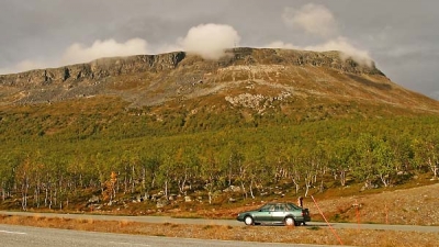 Saana fell (1029m + antenna) and our Volvo 440 in the afternoon sunlight, Kilpisjarvi, Finland