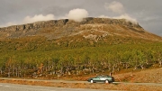 Saana fell (1029m + antenna) and our Volvo 440 in the afternoon sunlight, Kilpisjarvi, Finland