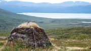TÃ¤ltlÃ¤gret, soil covered mountain shelter outside Abisko NP with TornetrÃ¤sk (DuortnosjÃ¡vri) lake in the background, Sweden