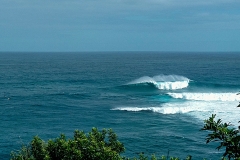 The beautiful Peʻahi/Jaws @ forecasted ~35ft (10m+) the morning after cyclone passed. There are 3 jet skis and one surfer in this photo for scale.